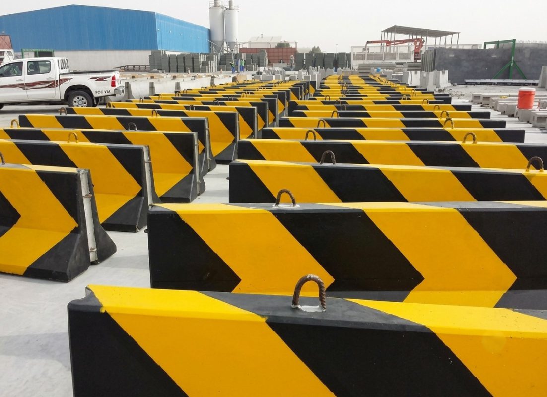 Yellow and black precast concrete safety barriers