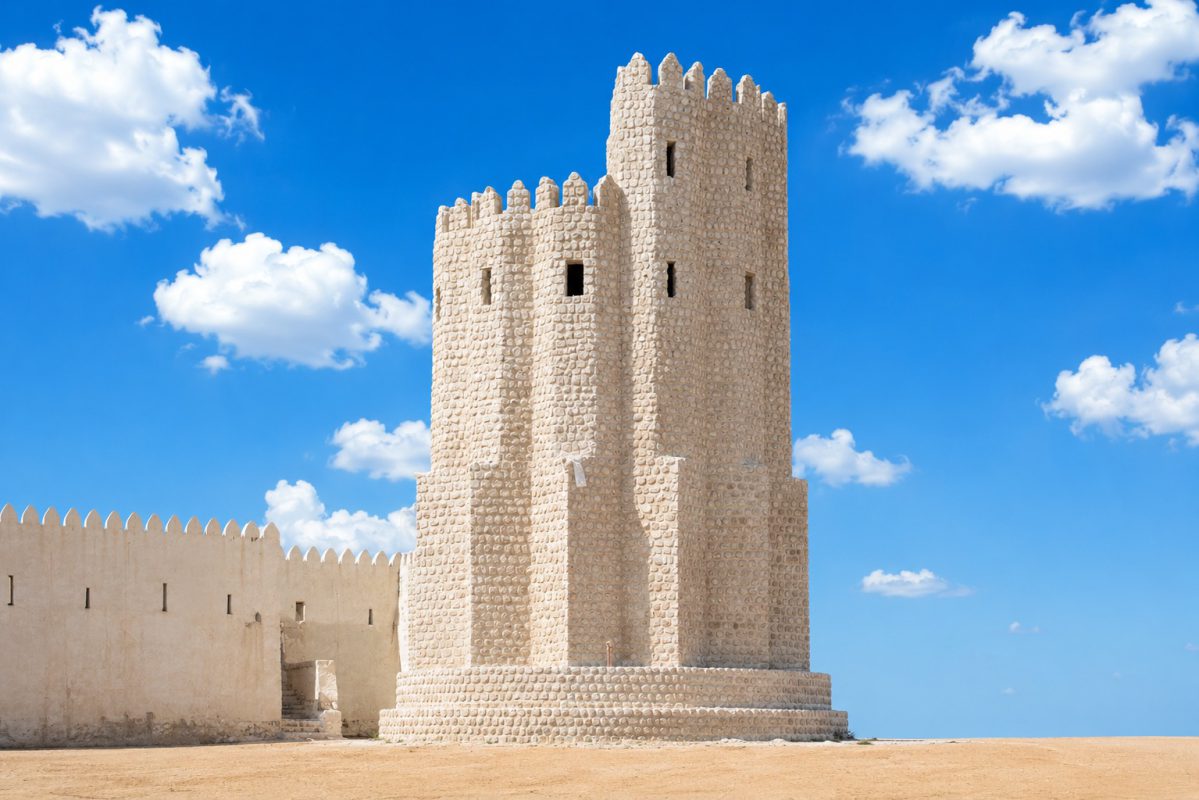 Heritage-style precast watch tower with stone-clad finish and fort wall