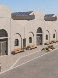 Precast horse stables at Al Wathba with arched openings and solar-shaded roofs