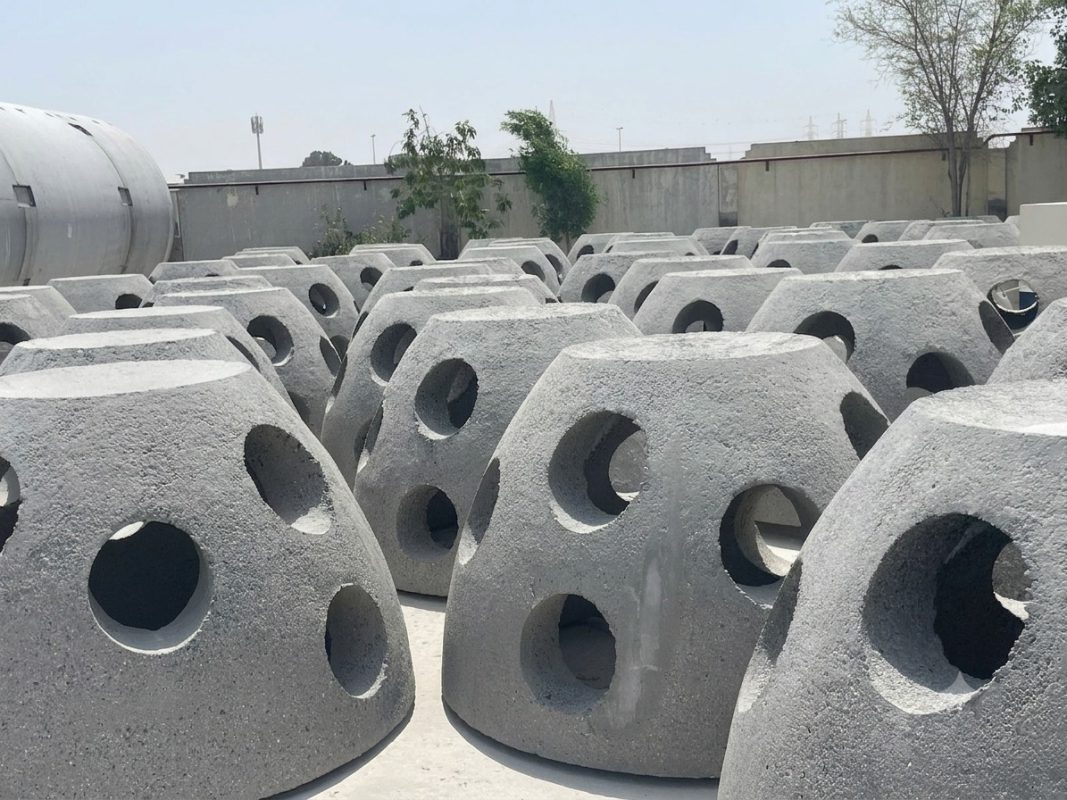 Precast concrete blocks with perforated openings stacked at the Al Wathba yard